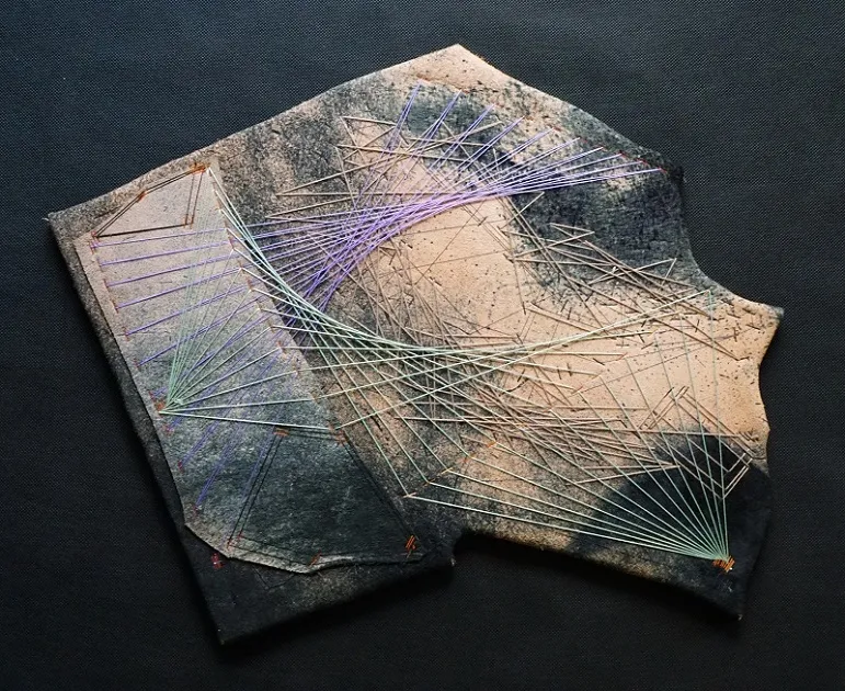             Scrap Work No.40, 2015, 43x54×1.5cm, metal, nylon and cotton threads on lather,
wood          